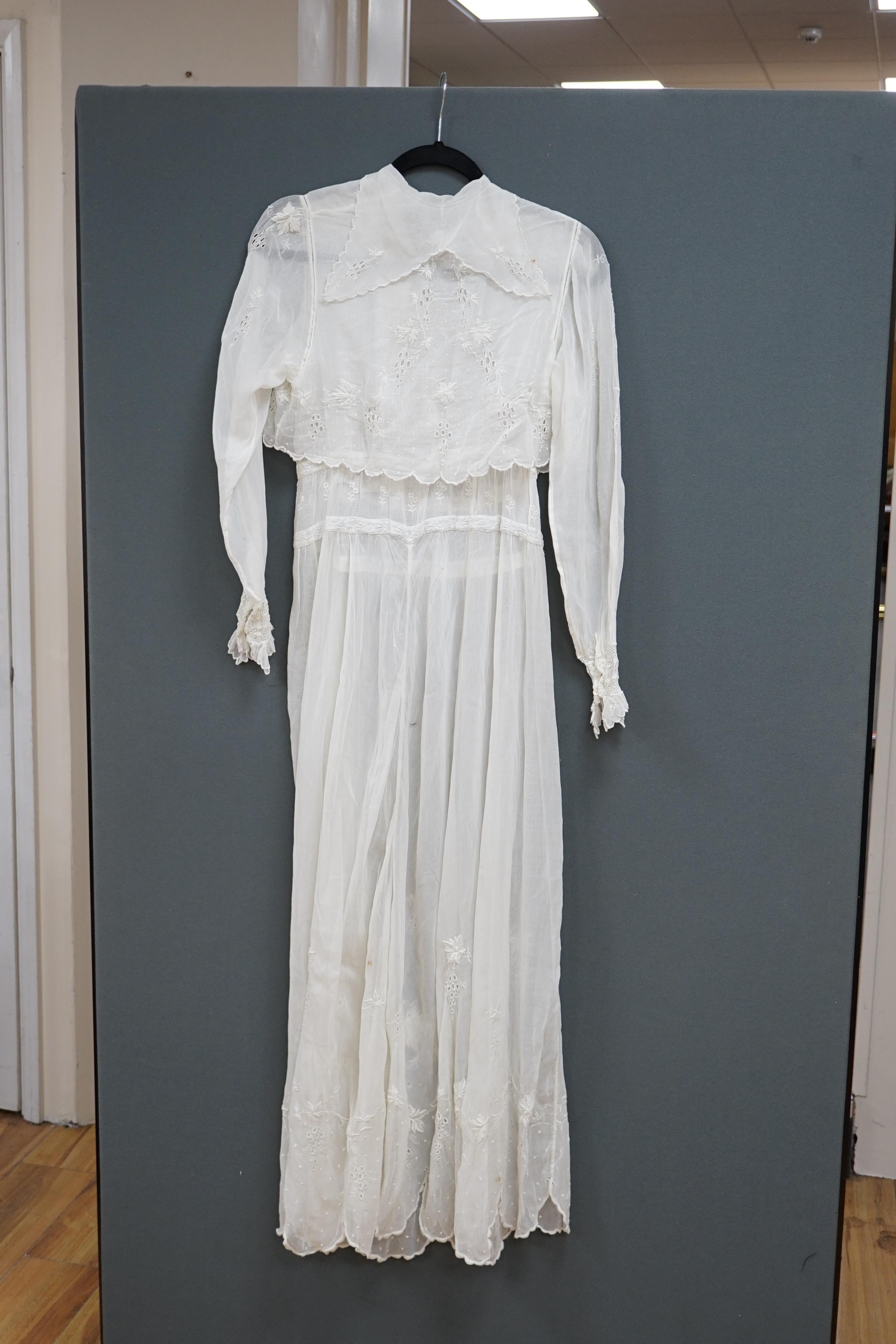 An early Edwardian fine lawn ladies hand made and embroidered crochet dress, embroidered with a white worked skirt, cuffs and lower waist and Irish crochet bodice insertions, with novelty detailing of a faux jacket front